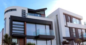 Contemporary luxury home with glass balconies in Poole, UK, showcasing modern architectural design. Contemporary luxury home with glass balconies in Poole, UK, showcasing modern architectural design.